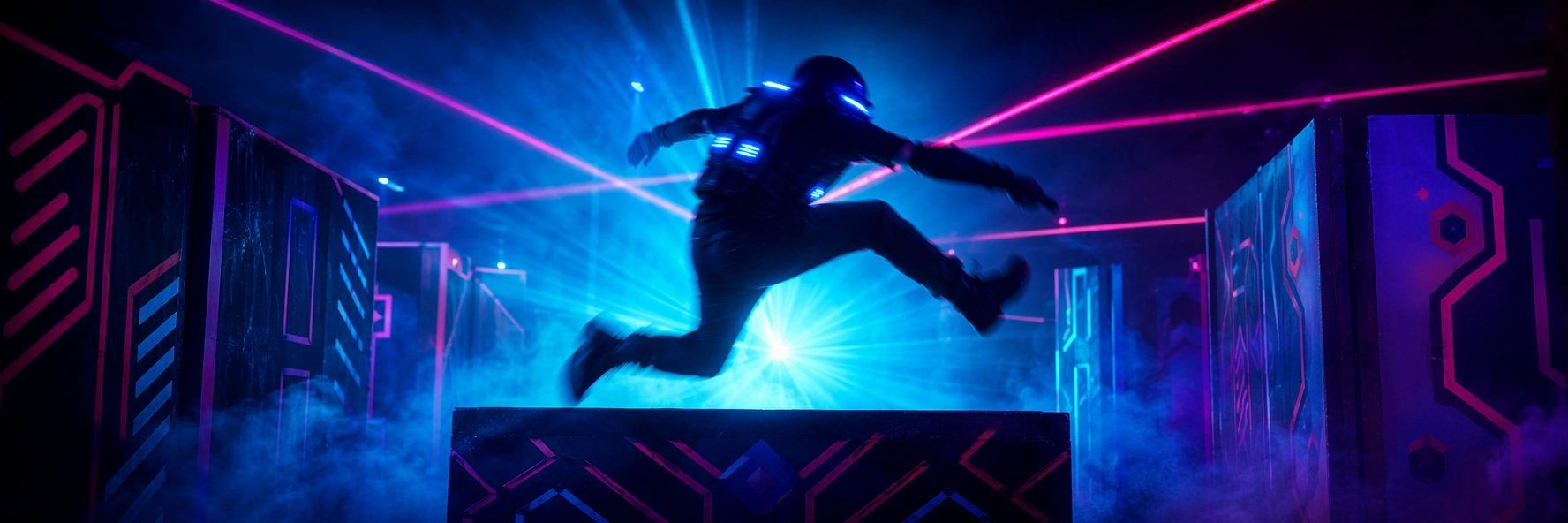 Indoor laser tag: a player vaulting over an obstacle in a fog-filled neon arena